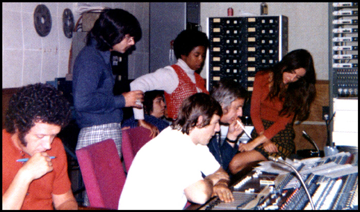 The singers squeezed into the control booth dominated by a massive mixing board, manned by sound technicians.